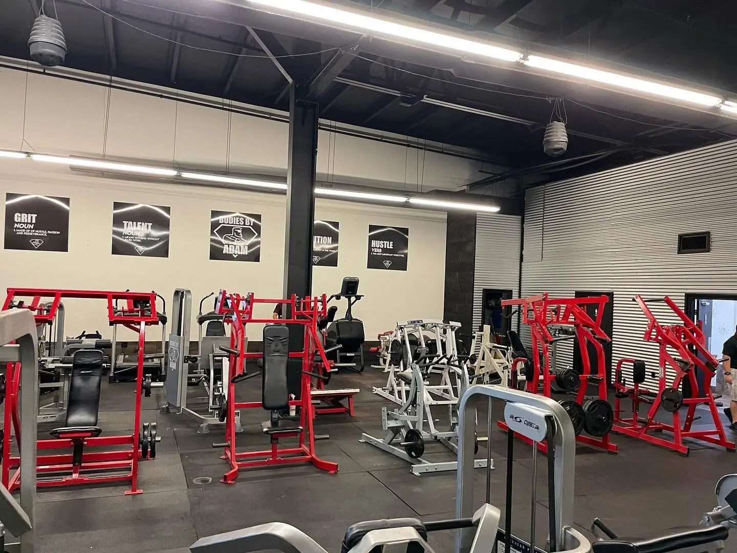 The Bodies by Adam training floor with red plate-loaded machines